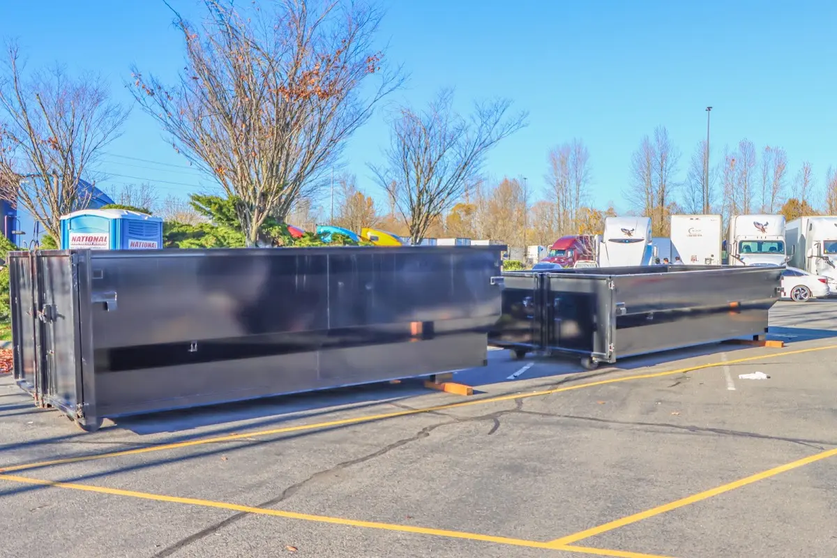 Professional dumpster rental service with roll-off container on residential driveway in Tice